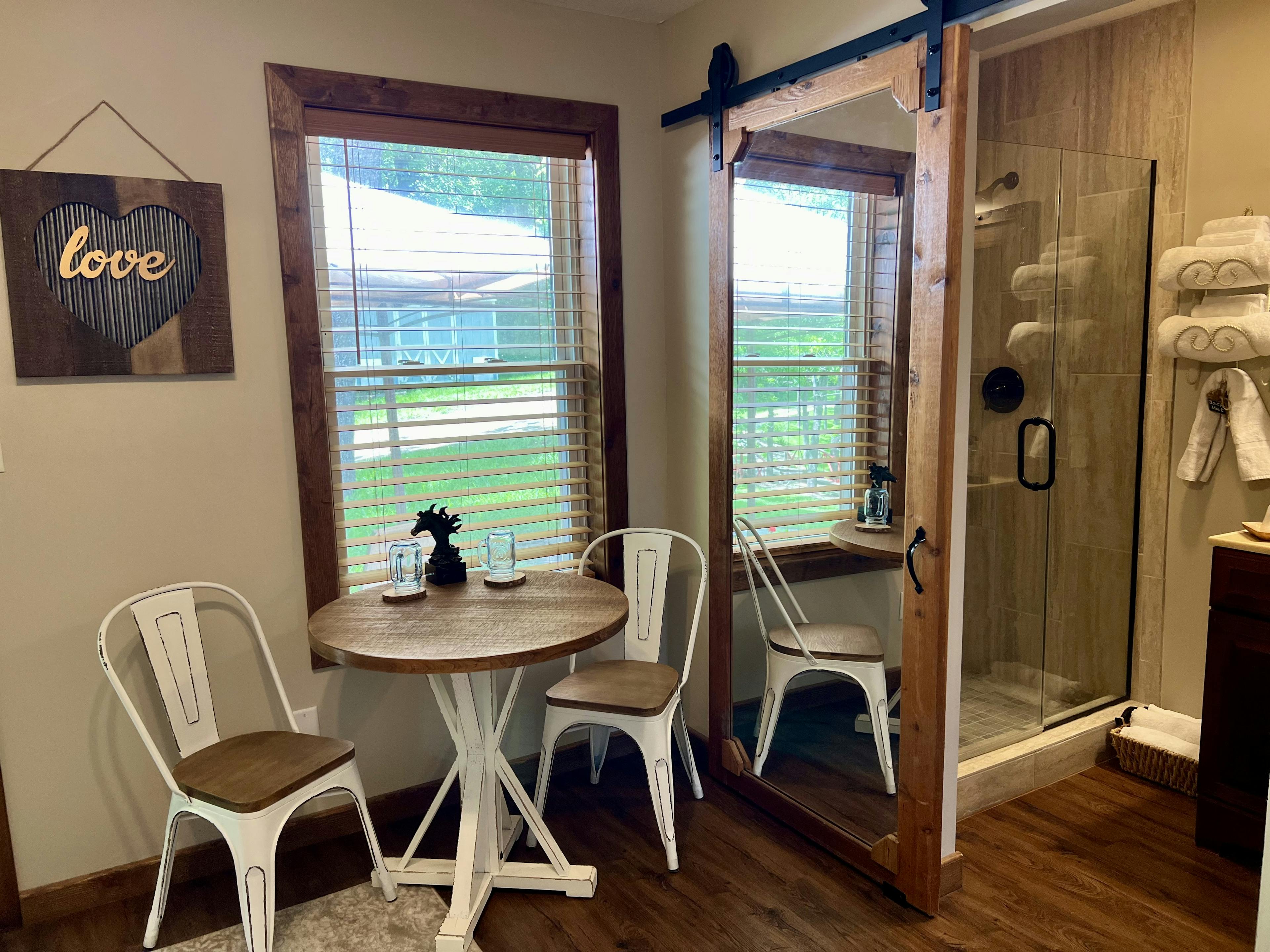 Small White and wood table and chair set by a window